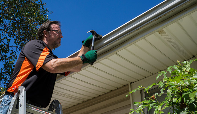 Expert installing gutter.