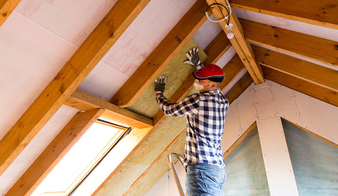 A professional insulating a roof